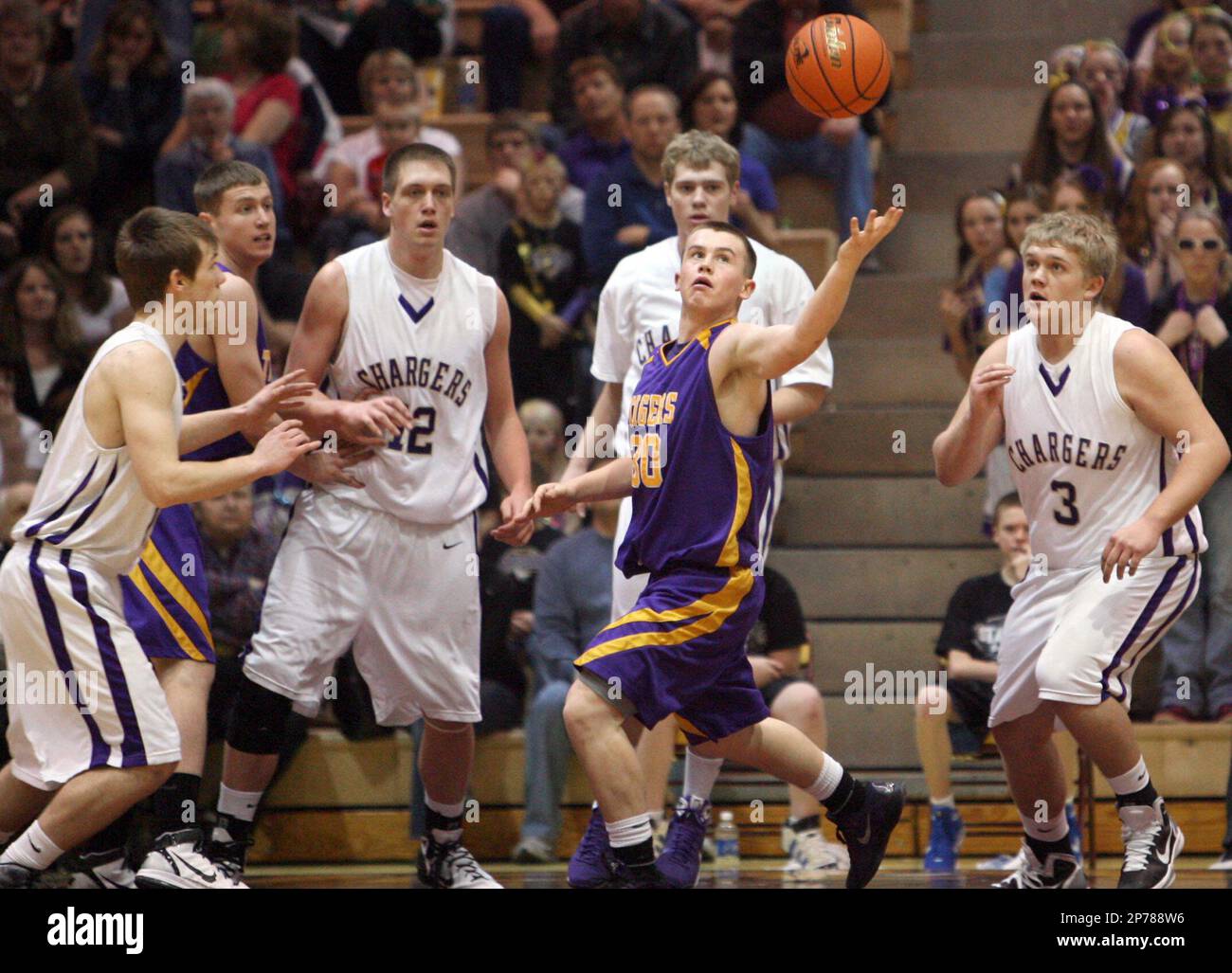White River's Wyatt Krogman, center, reaches back for the ball after he