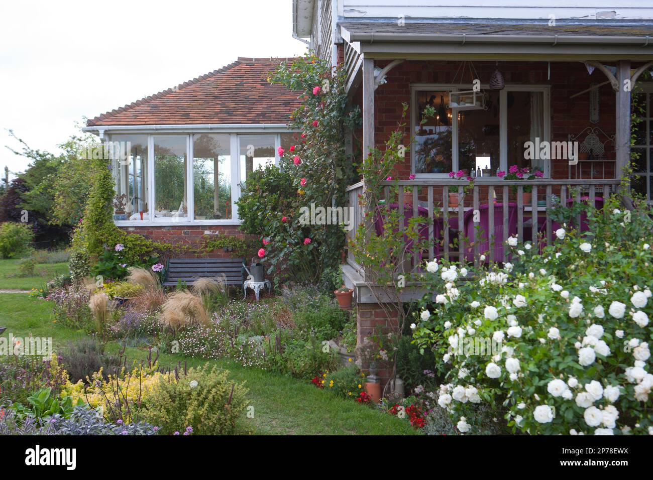 A sheltered seating area and large wooden deck with outdoor seating ...