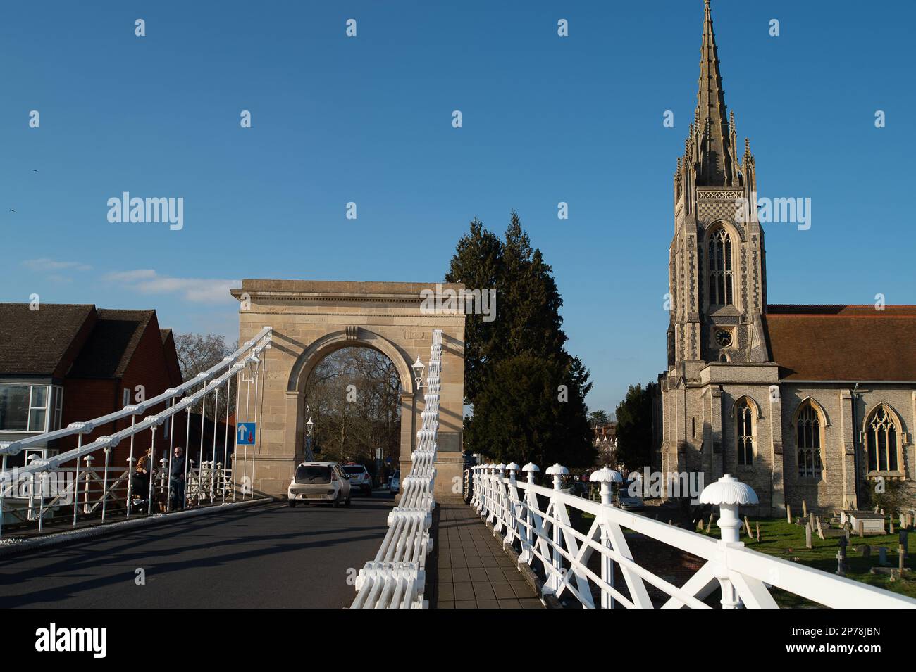 Marlow, Buckinghamshire, UK. 2nd March, 2023. Traffic crosses Marlow Suspension Bridge in Buckinghamshire. The bridge is a  Grade I Listed Building. Last year a petition was launched by locals to try to get the bollards on the bridge removed. They are there to stop HGVs crossing the bridge, however, many motorists have damaged their cars as they try to squeeze through the tight gap on the road lined by bollards. Credit: Maureen McLean/Alamy Stock Photo