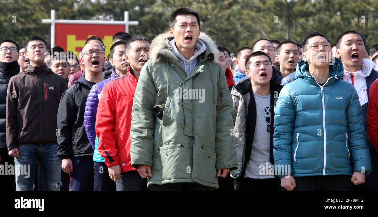 South Korean actor Hyun Bin, center, sings a song during an admission