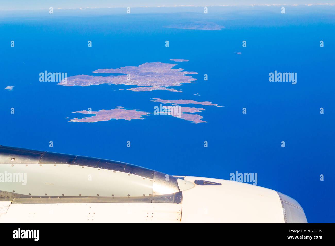 Aerial view from flying airplane to Santorrini. Mikonos, Rineia and Dilos islands-part of Cyclades group in Aegean Sea seen from above ,Greece Stock Photo