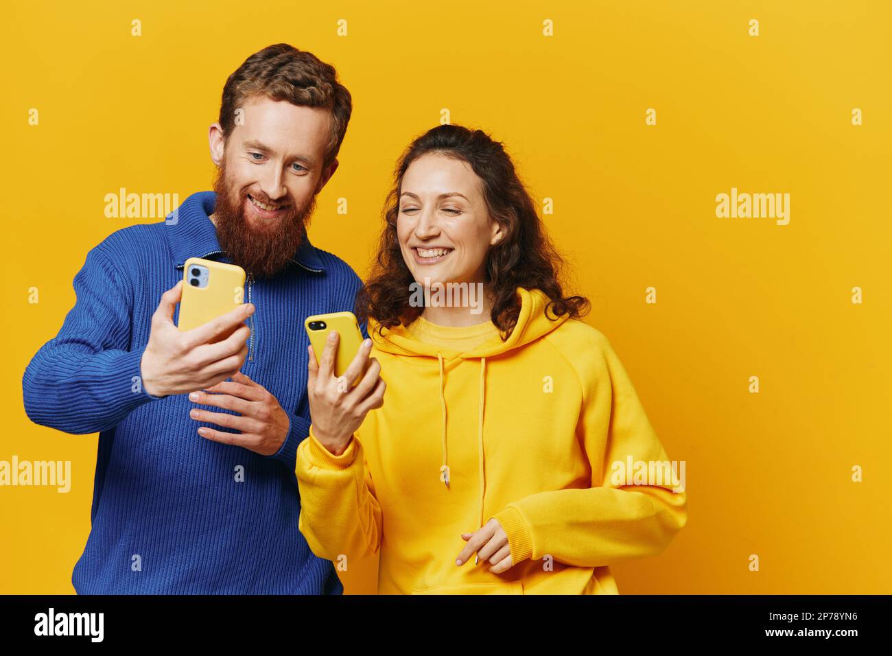 Man and woman couple smiling merrily with phone in hand social media ...