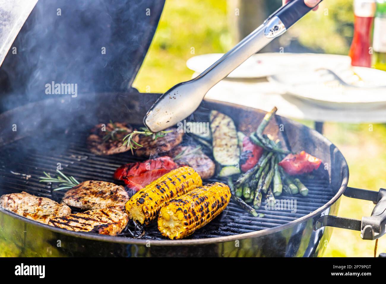 Charcoal grill in the garden with steaks and vegetarian barbecue
