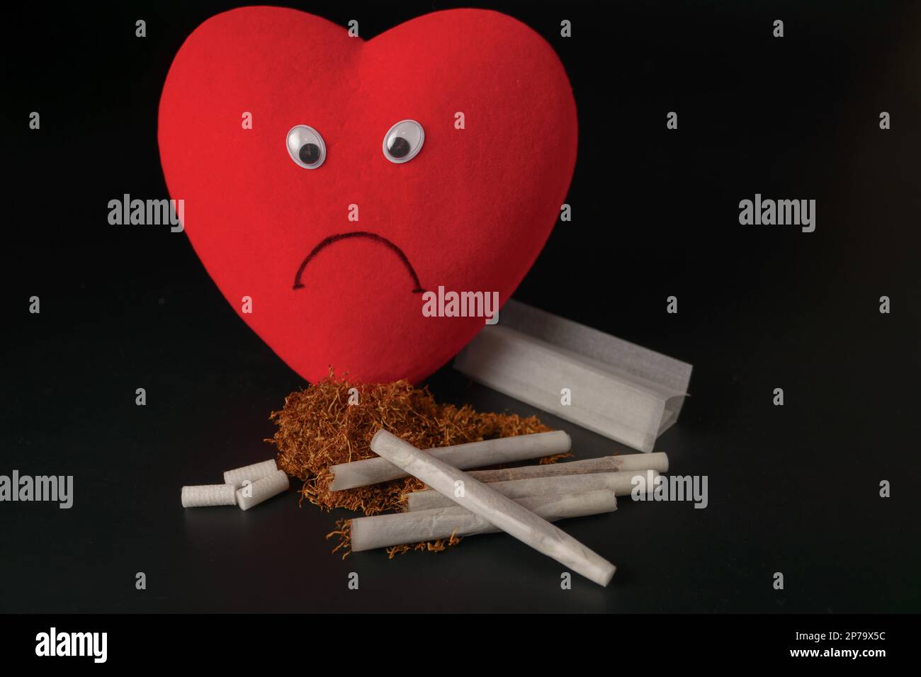 cigarettes and heart sad heart with cigarettes and tobacco concept of unhealthy habits Stock  Photo