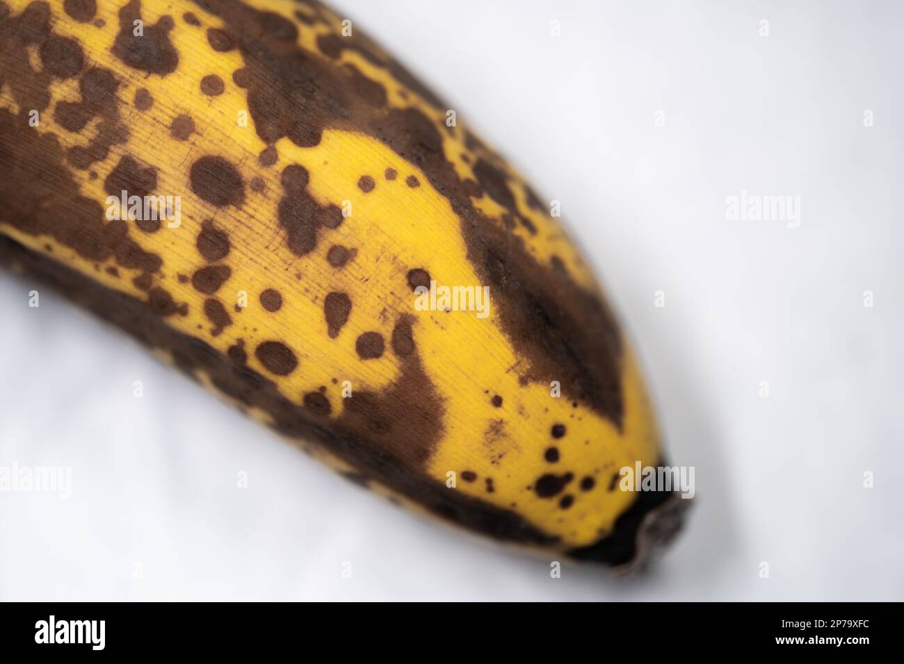 Banana with dark spots. Ripe banana. Isolated on white background. Selective focus. Stock Photo
