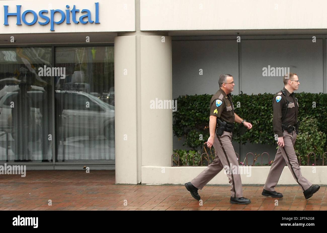 Sergeant Russ Clithero and Deputy Chris Andrews of the Kitsap County Sheriff's Department exit