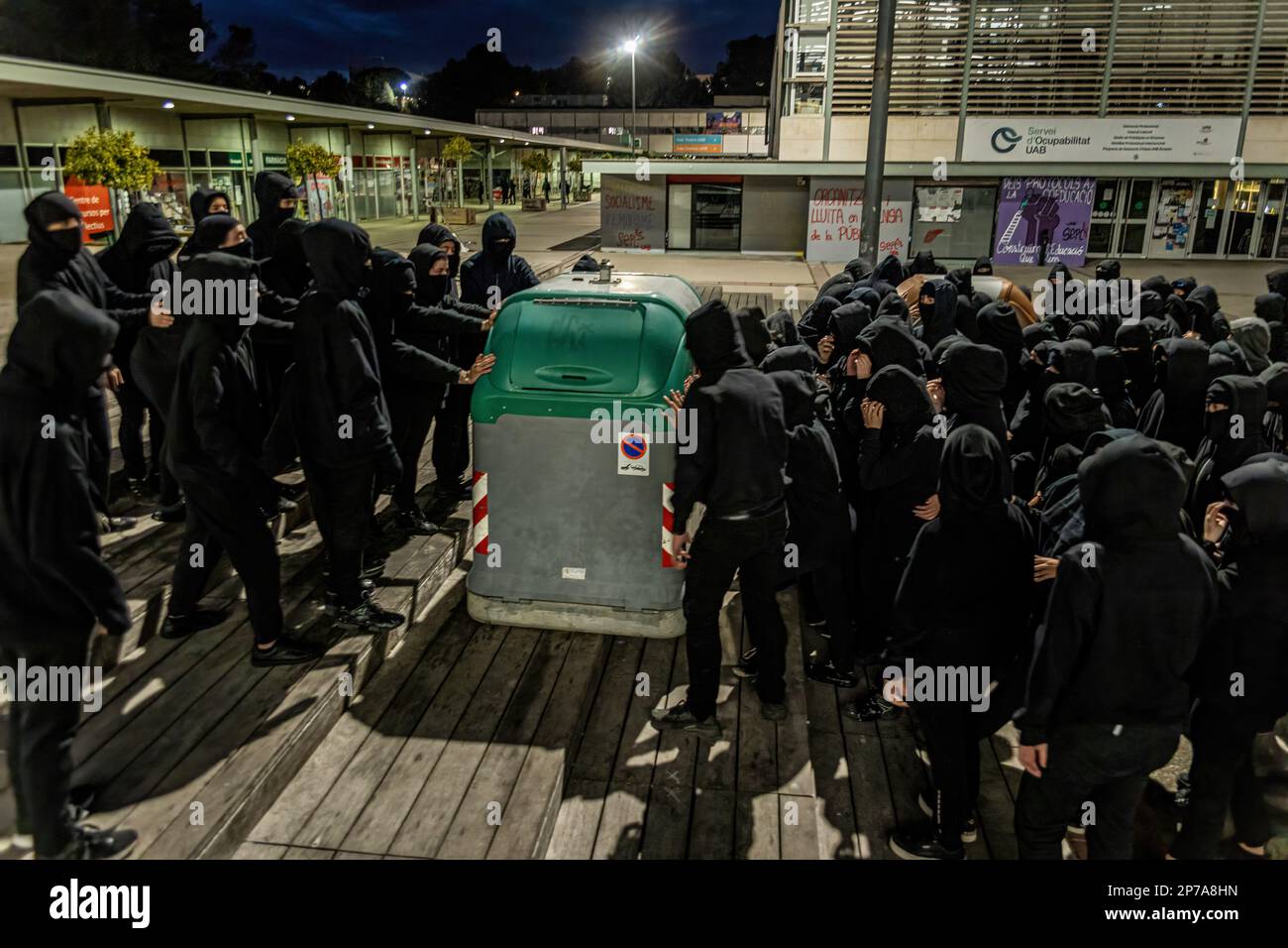 Barcelona, Spain. 08th Mar, 2023. Hooded students move a container to block the entrances during the International Woman's Day strike. The students of the Autonomous University of Barcelona staged an 8 March strike on the occasion of International Woman's Day, blocking the entrance to the Autonomous University of Barcelona for students attending class to demand a much more feminist perspective in the education system. Credit: SOPA Images Limited/Alamy Live News Stock Photo