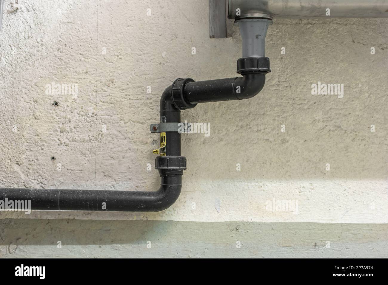 Large plastic sink plumbing pipes connected to metal sink. Front view no people Stock Photo Alamy