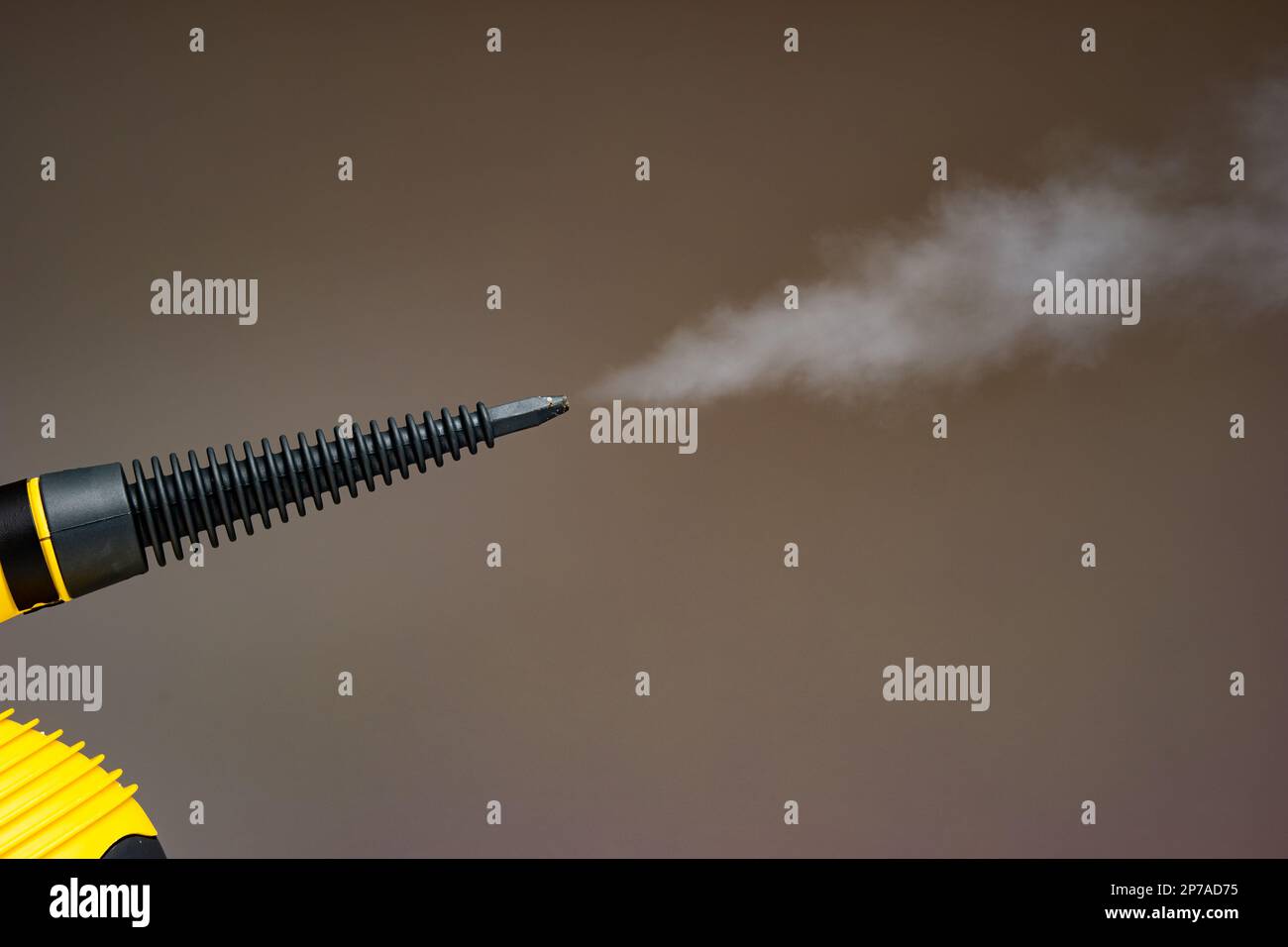 Steam pressure cleaner plastic nozzle spraying water vapor cloud. Close up studio shot, no