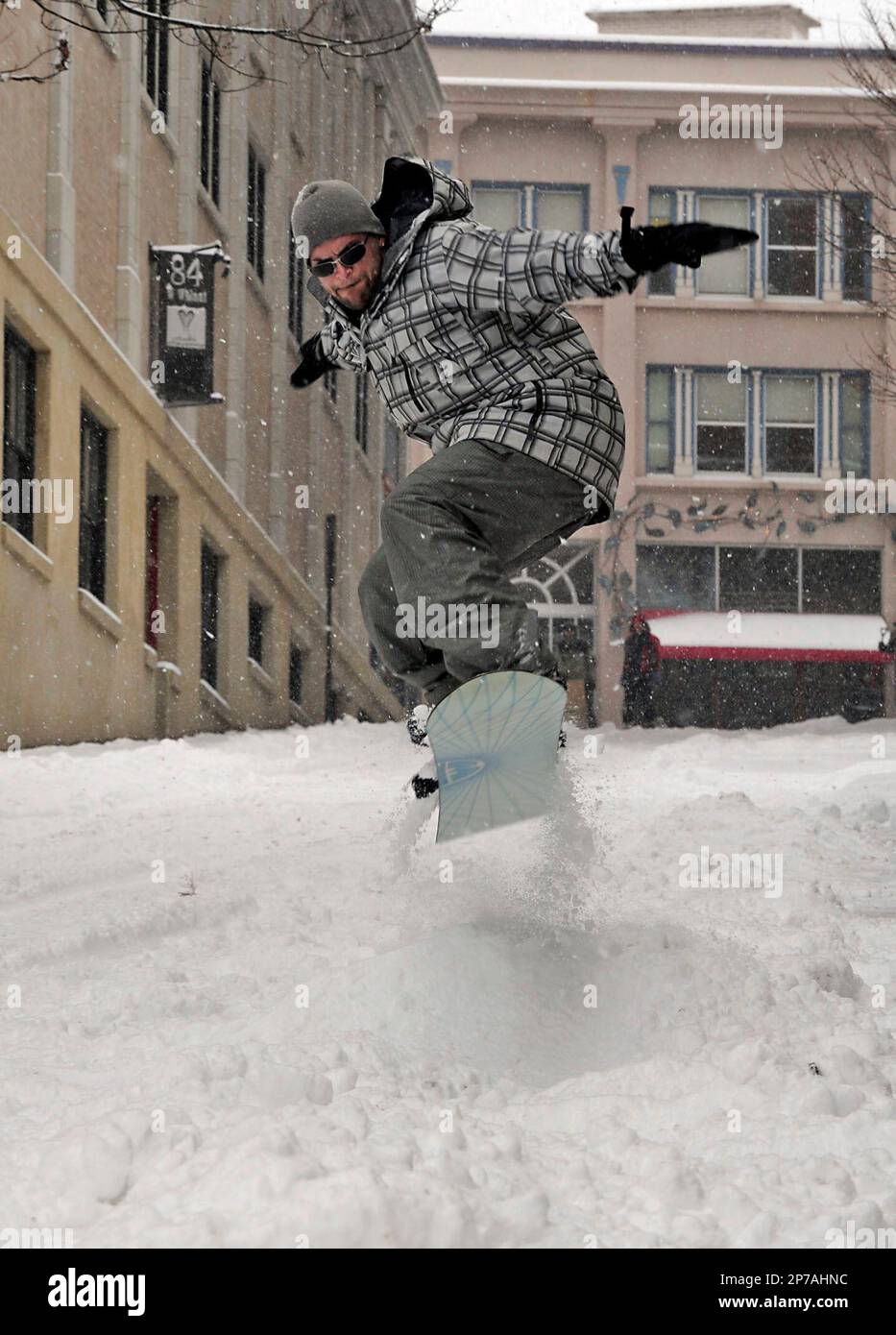 Todd Kriedt, of Asheville, N.C., gets airborne as he snow boards down  Walnut Street in downtown Asheville Monday, January 10, 2011. Asheville was  blanketed by 10 inches of snow Monday. (AP Photo/The