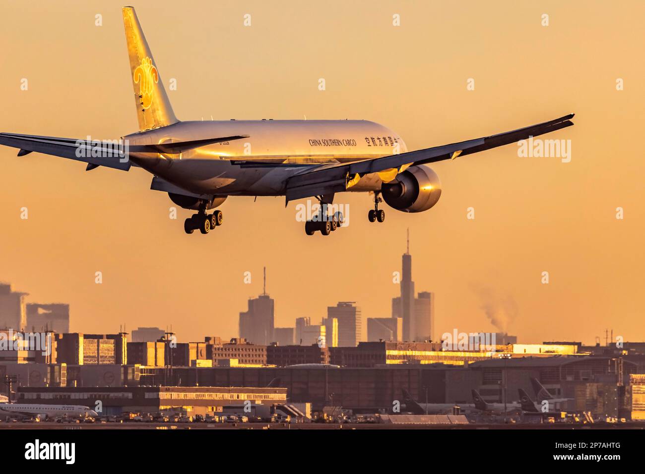 Fraport Airport with skyline in the early morning, cargo aircraft of the type Boeing 777F of the airline China Southern Airlines, on approach Stock Photo