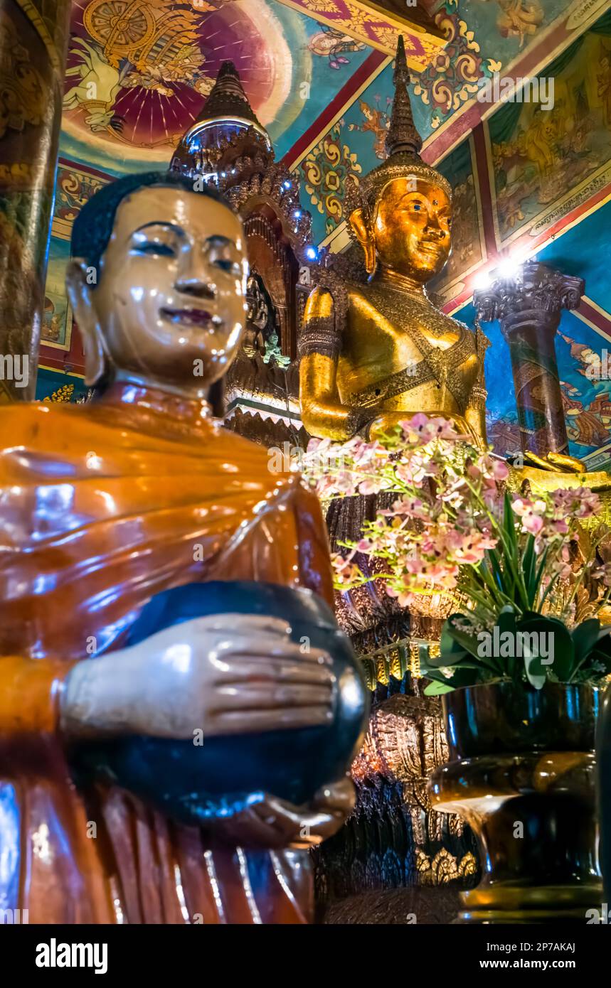 The main Buddha statue within the main alter at the ancient buddhist Wat Phnom in Phnom Penh, Cambodia. Stock Photo
