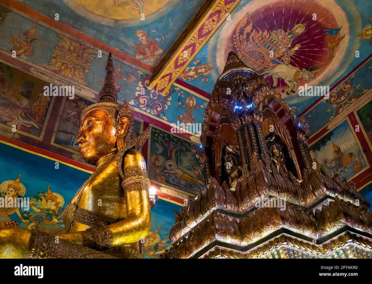 A Buddha statue within the main alter at the ancient buddhist Wat Phnom in Phnom Penh, Cambodia. Stock Photo