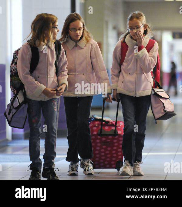 The Cox triplets, from left, Cassidy, Courtney and Caitlin, arrive at