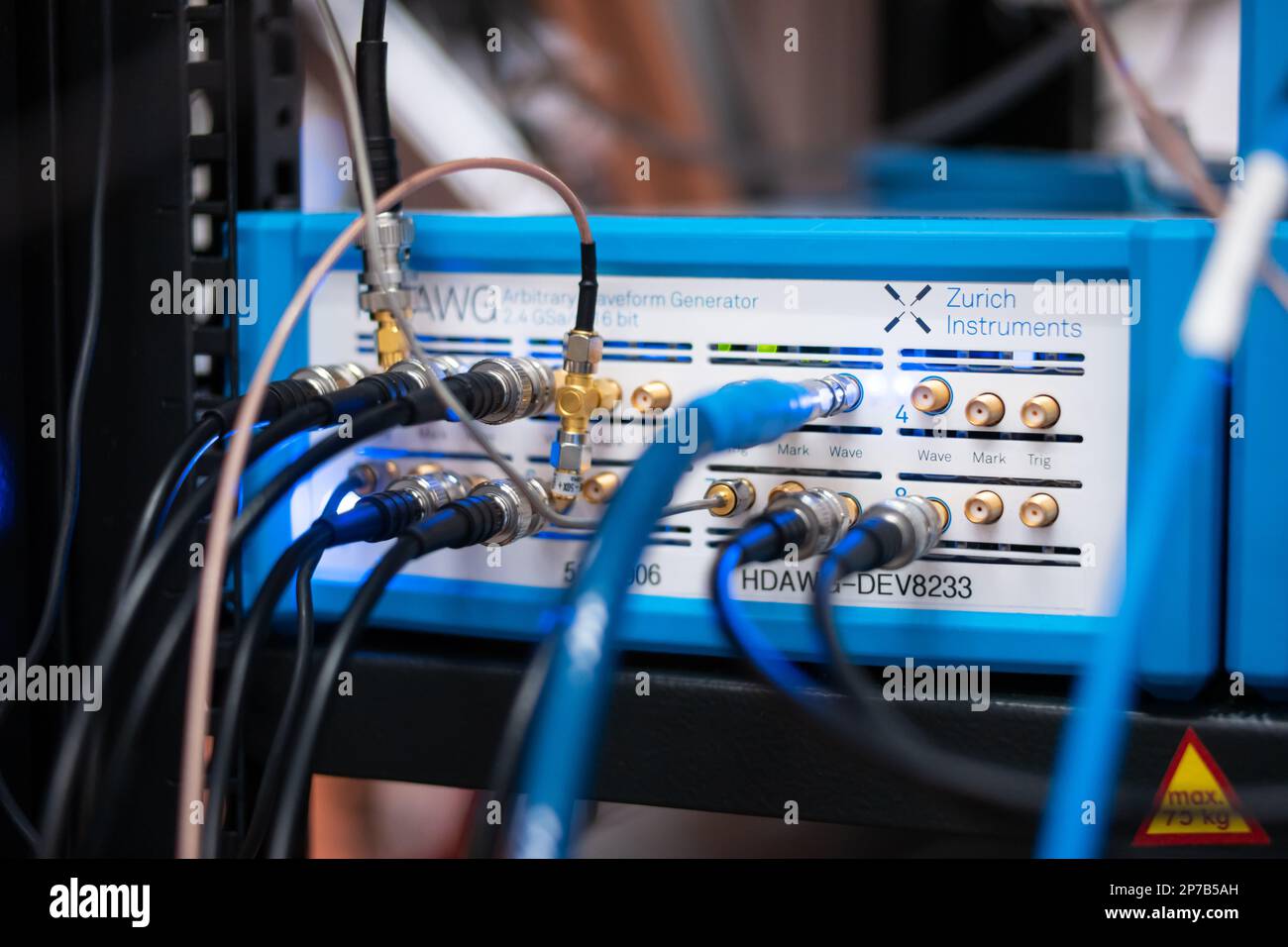 Science lab signal measuring and processing device. Many connected cables, shallow depth of field, no people. Stock Photo