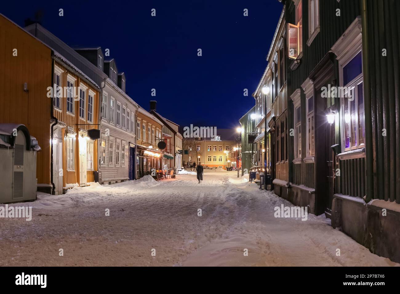 The snowy street in the touristic district Bakklandet after snowfall in the spring , Trondheim. Stock Photo