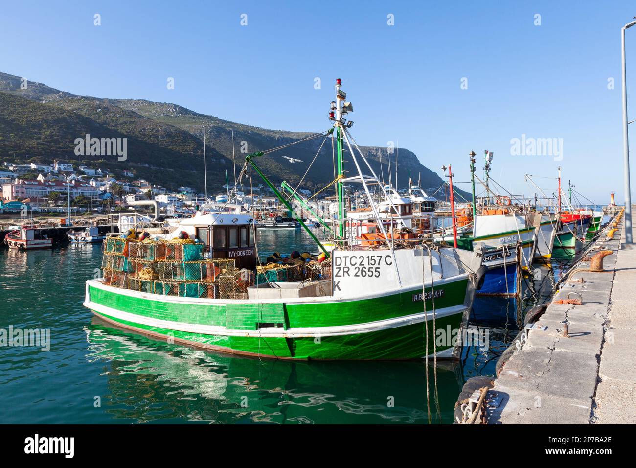 Fishing boats moored in Kalk Bay Harbour, Cape Town, Western Cape, South Africa at sunset, A popular tourist attraction and fish market Stock Photo