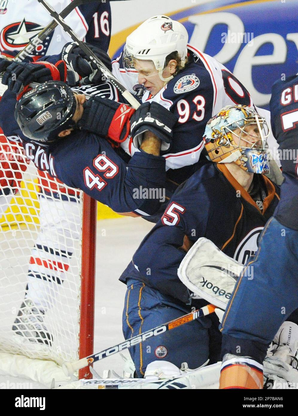 Edmonton Oilers' Theo Peckham, left, and the Columbus Blue Jackets ...