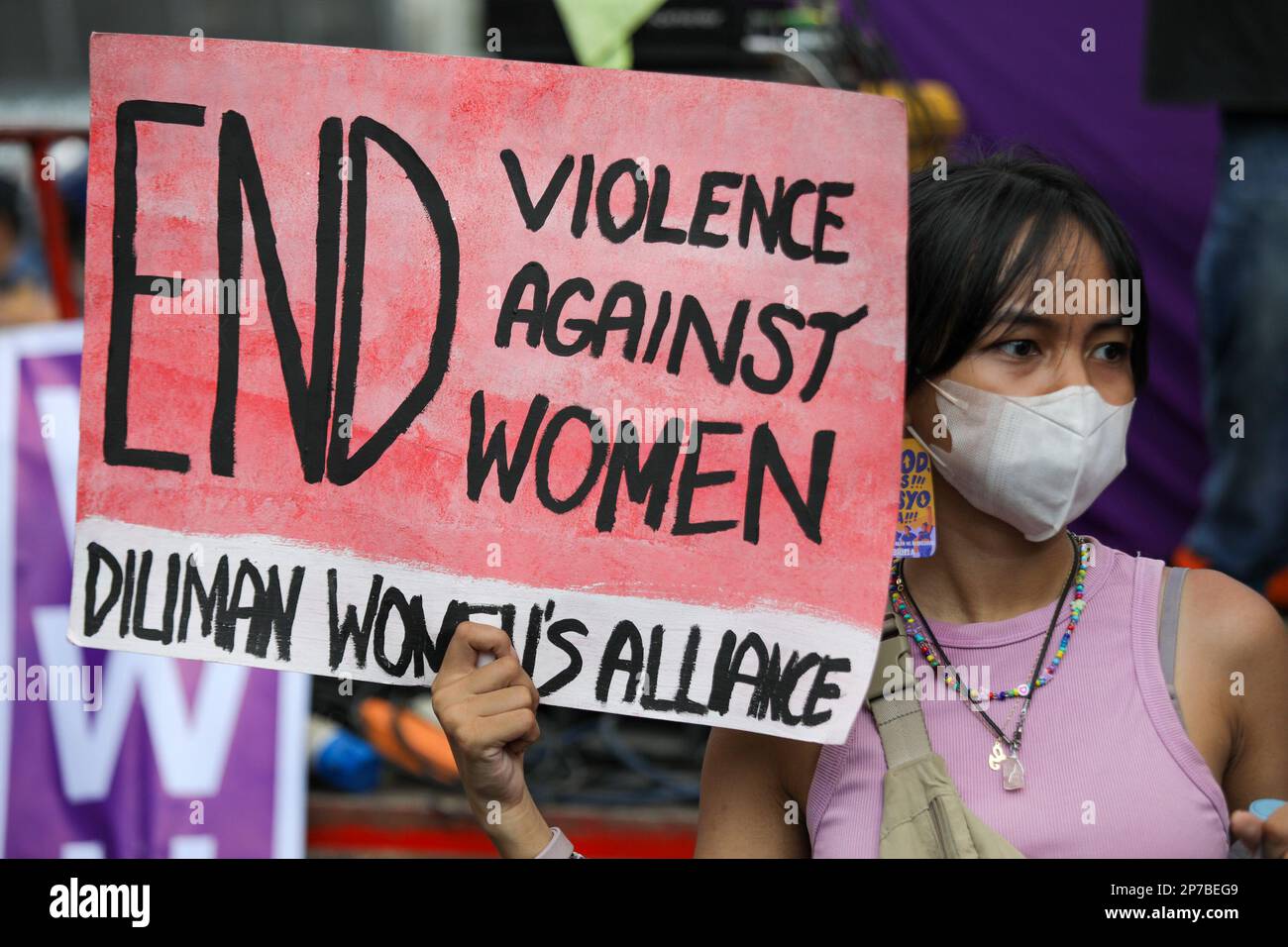 Manila, Philippines. 8th Mar, 2023. A woman holds a sign as protesters