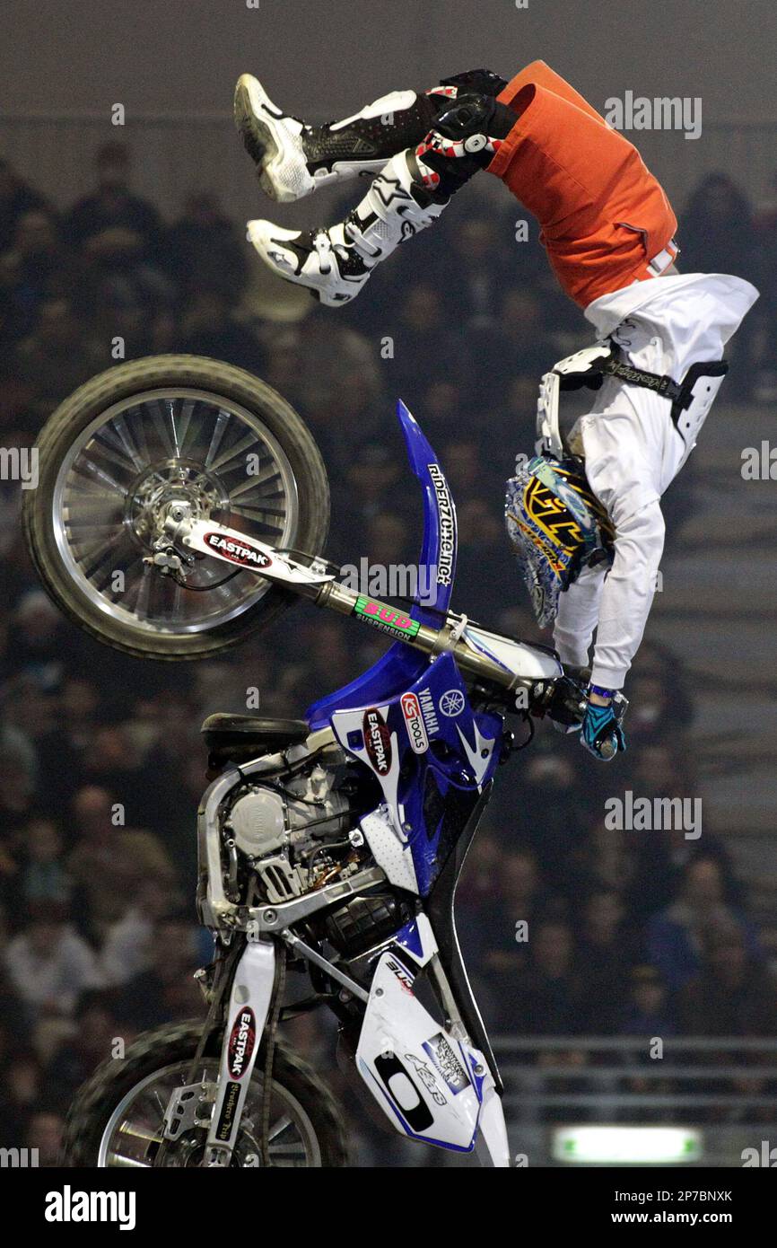 French competitor Tom Pages performs a figure during the jump contest FMX  at the 25th Geneva International Supercross at the Palexpo, in Geneva,  Switzerland, Friday, Dec. 3, 2010. (AP Photo/Keystone/Salvatore Di Nolfi