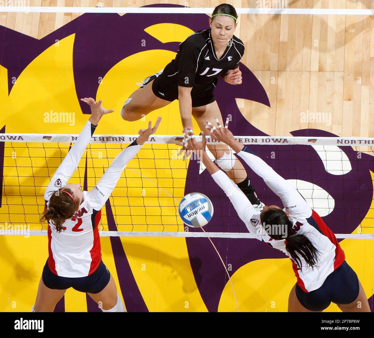 Northwesterns Sabel Moffett, top, smashes the ball past Arizonas Kaylen Bannister, left, and Whitney Dosty, right, during a match in round one of the NCAA Division I Womens Volleyball Championships on Friday,