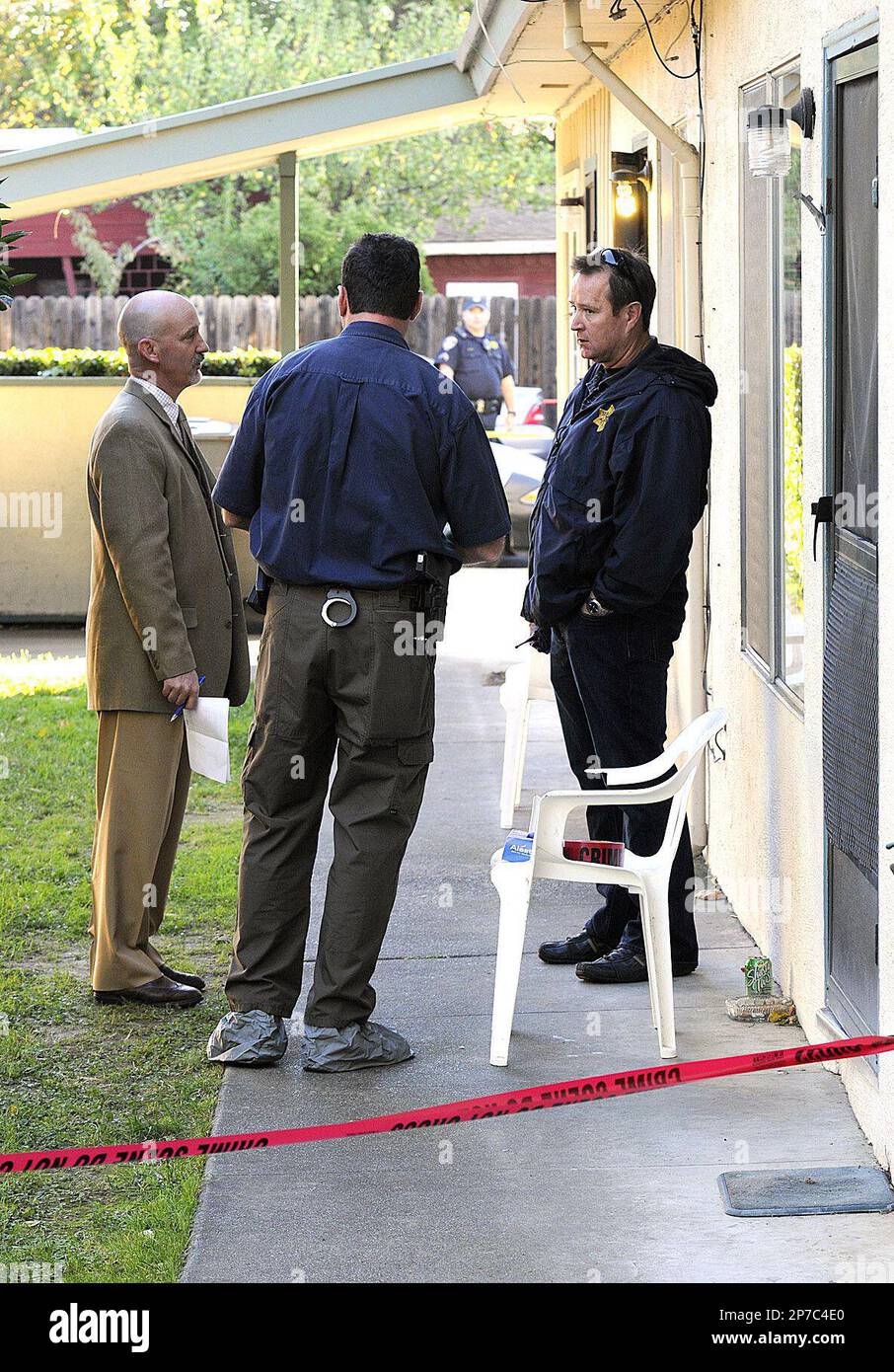 Solano County District Attorney Investigator Kurtis Cardwell, left,  Vacaville Police Detective Todd Dye, center, and Sgt. Jeff King stand  outside an apartment on Tuesday, Nov. 16, 2010 in Vacaville, Calif.  Authorities say