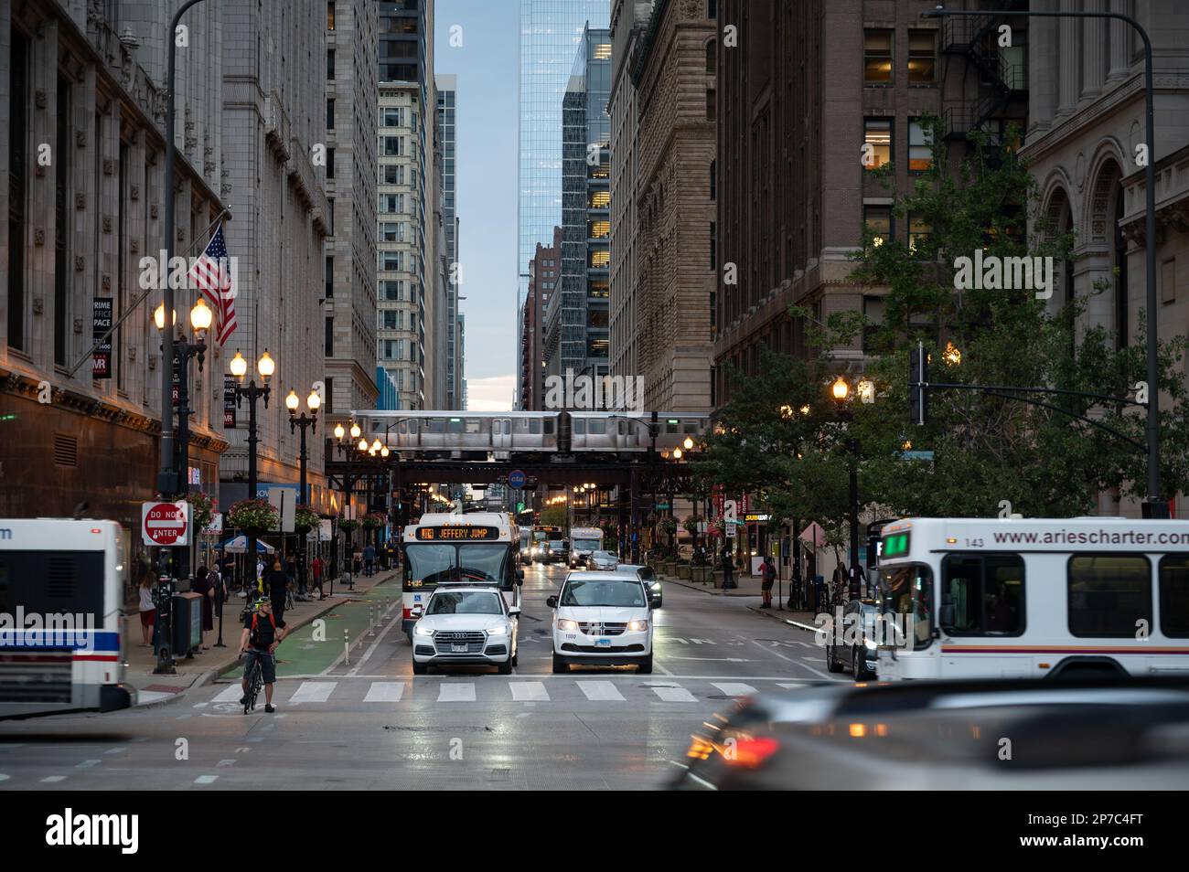 Urban Chicago street bustling with life and cars commuting Stock Photo