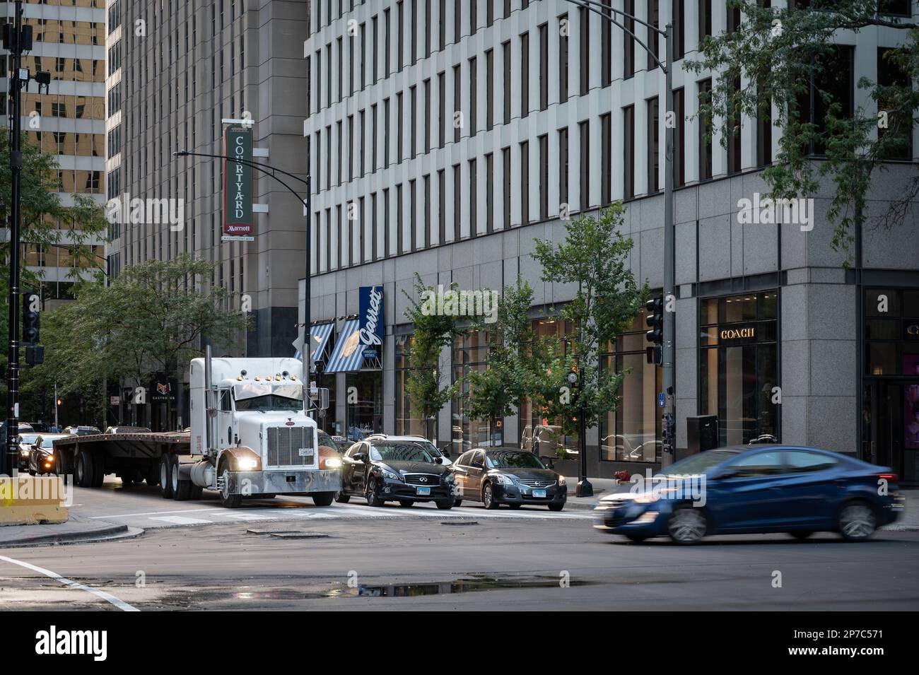 Urban Chicago street bustling with life and cars commuting Stock Photo