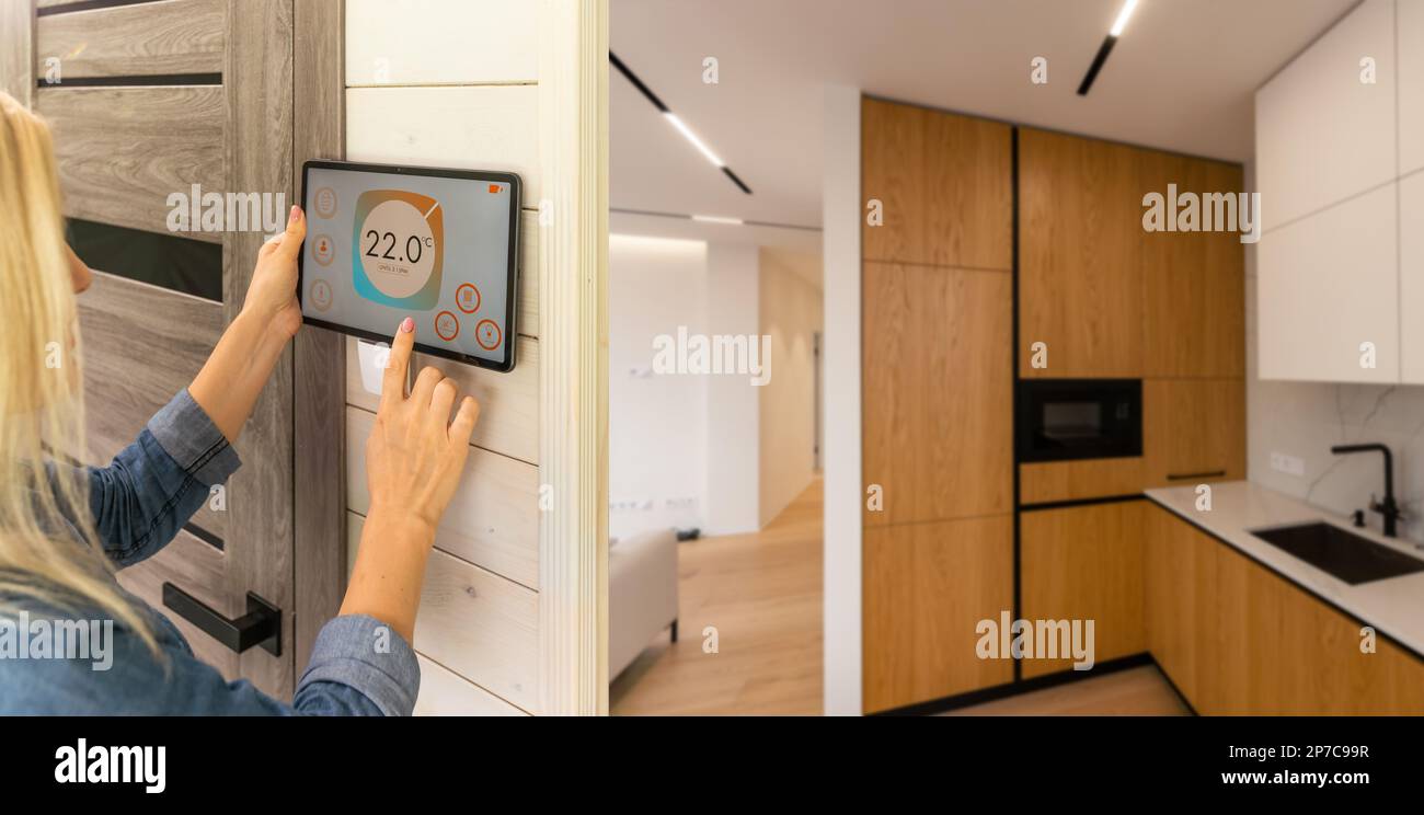 Woman using smart wall home control system Stock Photo