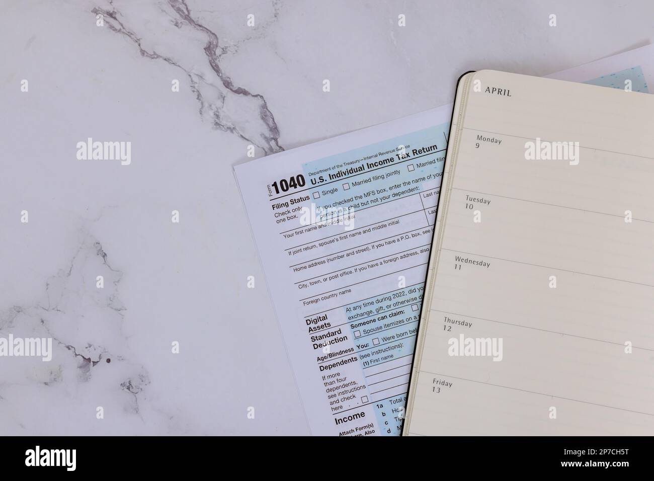 Tax season time US with federal individual income tax return 1040 form on desk Stock Photo