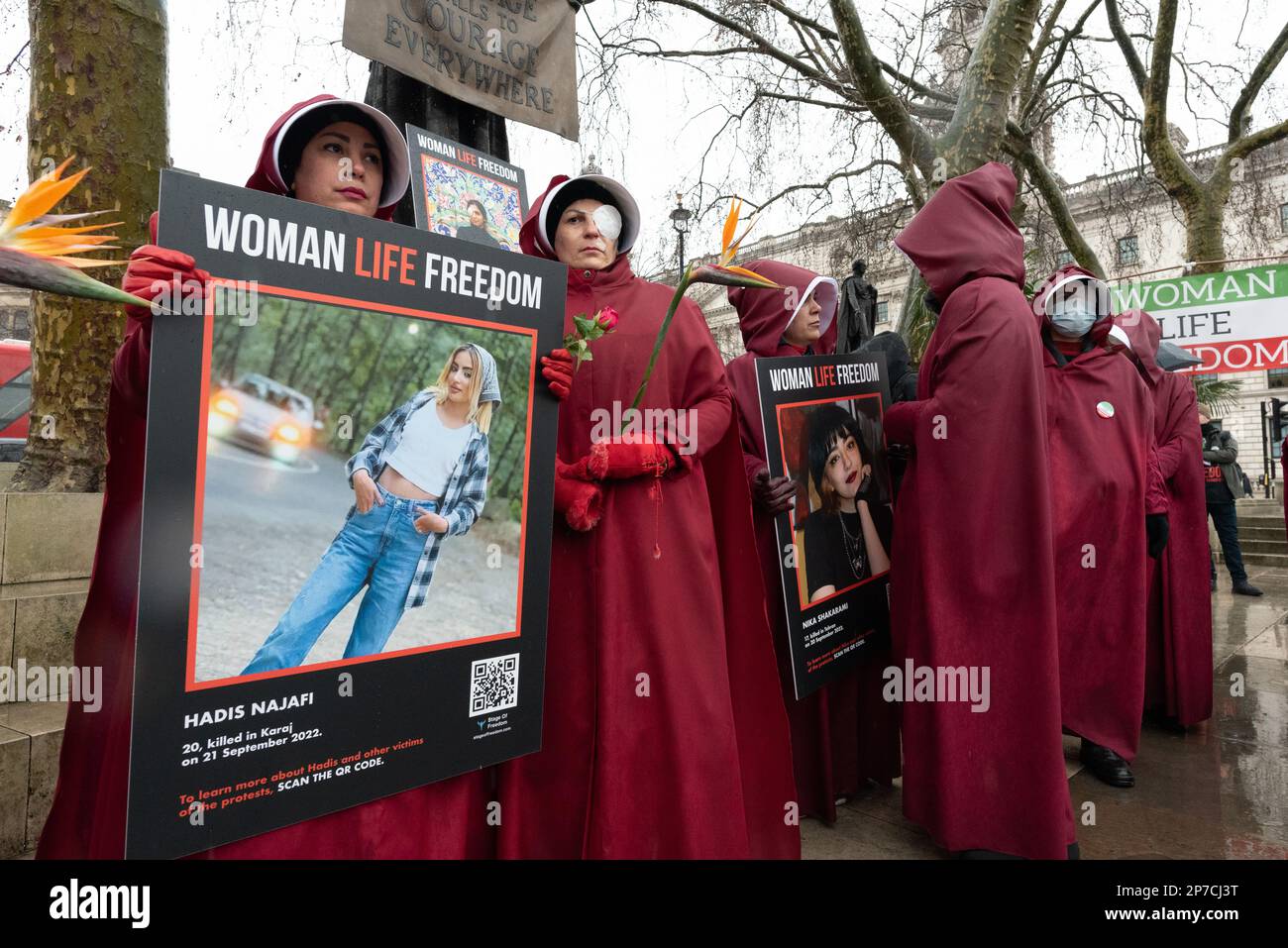 Parliament Square, London, UK. 8th March 2023. British-Iranian women, dressed as characters from The Handmaid's Tale, mark International Women's Day i Stock Photo
