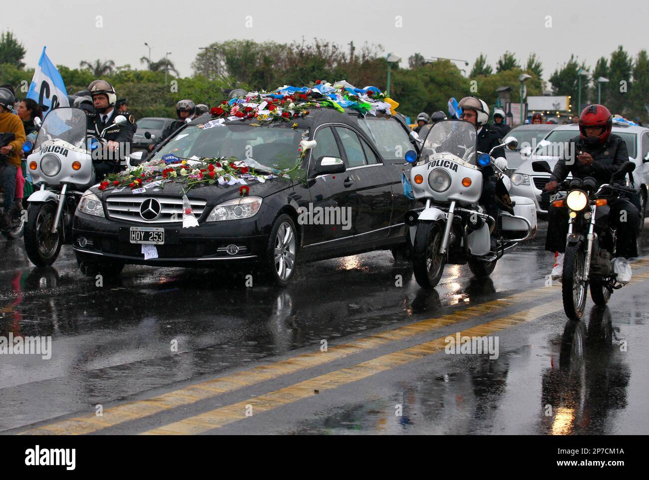police-officers-guard-the-hearse-carrying-the-coffin-with-the-remains-of-late-argentinas-president-nestor-kirchner-during-a-funeral-procession-to-the-airport-through-the-streets-of-buenos-aires-argentina-friday-oct-29-2010-kirchners-remains-will-be-flown-to-rio-gallegos-in-the-southern-region-of-patagonia-where-he-was-born-for-burial-ap-photoroberto-candia-2P7CM1A.jpg
