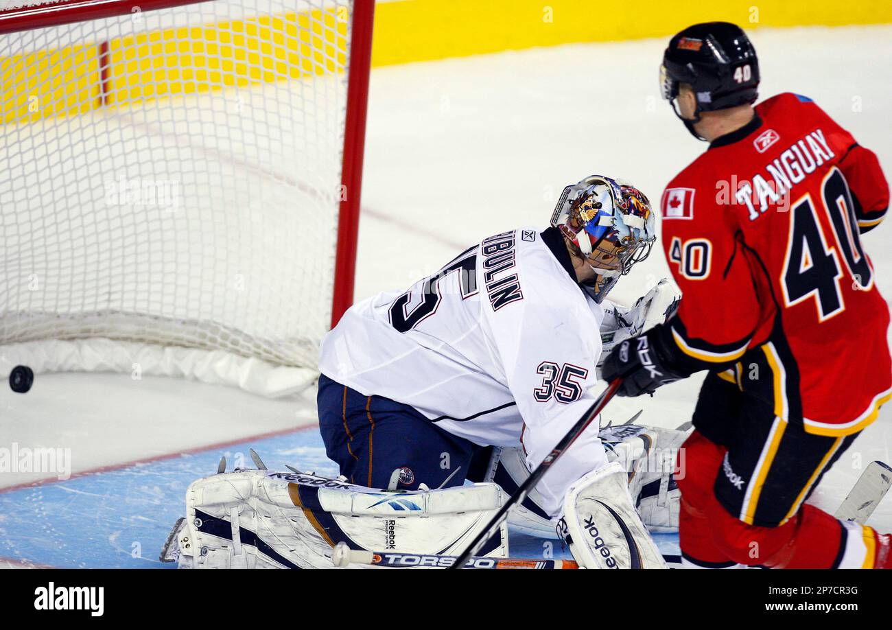 Edmonton Oilers goalie Nikolai Khabibulin, left, from Russia, lets in a ...
