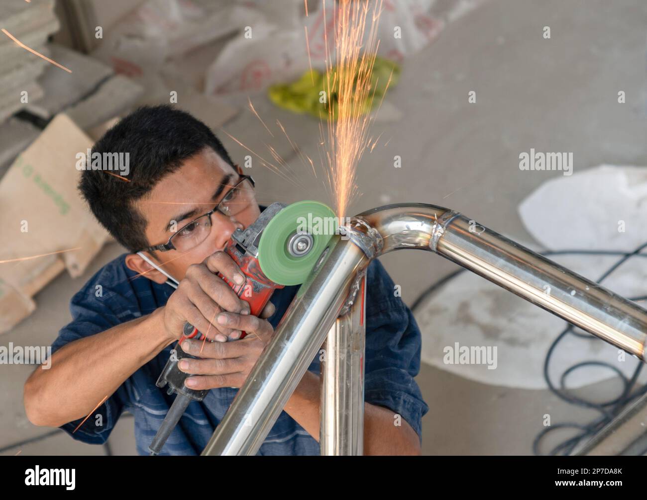 Workers use grinder to polish. Stainless steel Varnish in building site