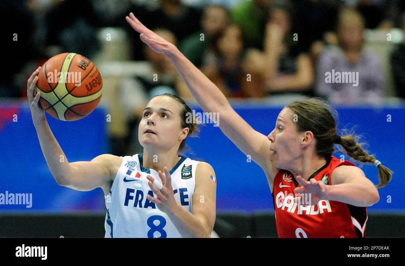 Clemence Beikes of France, left, is guarded by Kimberley Smith of Canada,  right, during their World Basketball Championship round of 16 match in  Ostrava, Czech Republic, Wednesday, Sept. 29, 2010. (AP Photo/CTK,