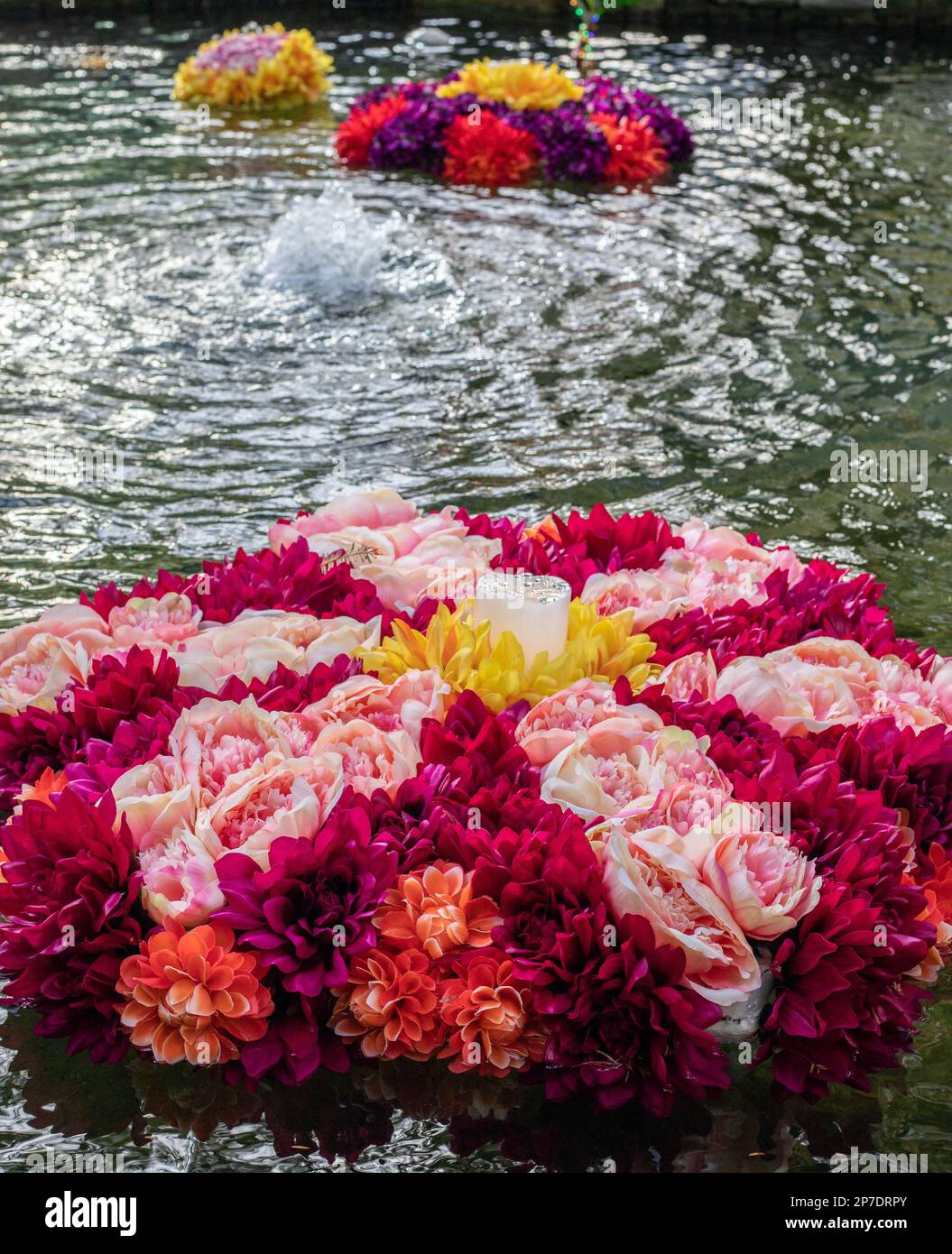 Colourful rangoli flowers float in a pool of water to celebrate Diwali Stock Photo