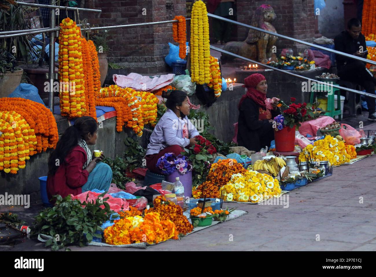 Kathmandu, Bagmati, Nepal. 8th Mar, 2023. Women sell flowers in front of a temple on