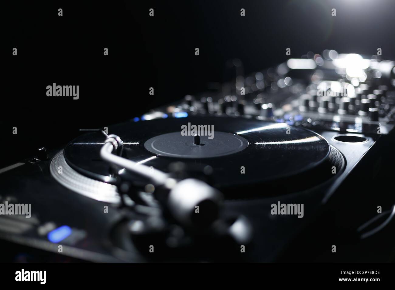 DJ setup on concert stage. Professional vinyl turntable and sound mixer