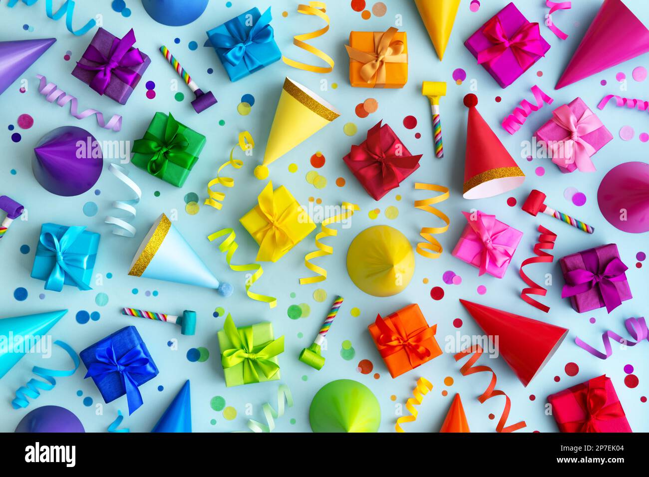 Overhead background collection of colorful birthday party objects in rainbow colors Stock Photo