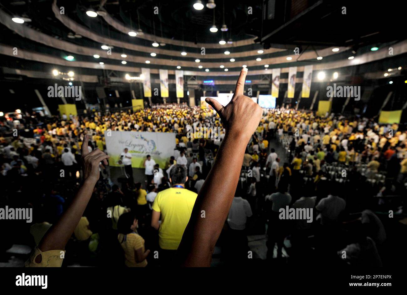 Supporters of the late Philippine President Corazon Aquino flash the ...