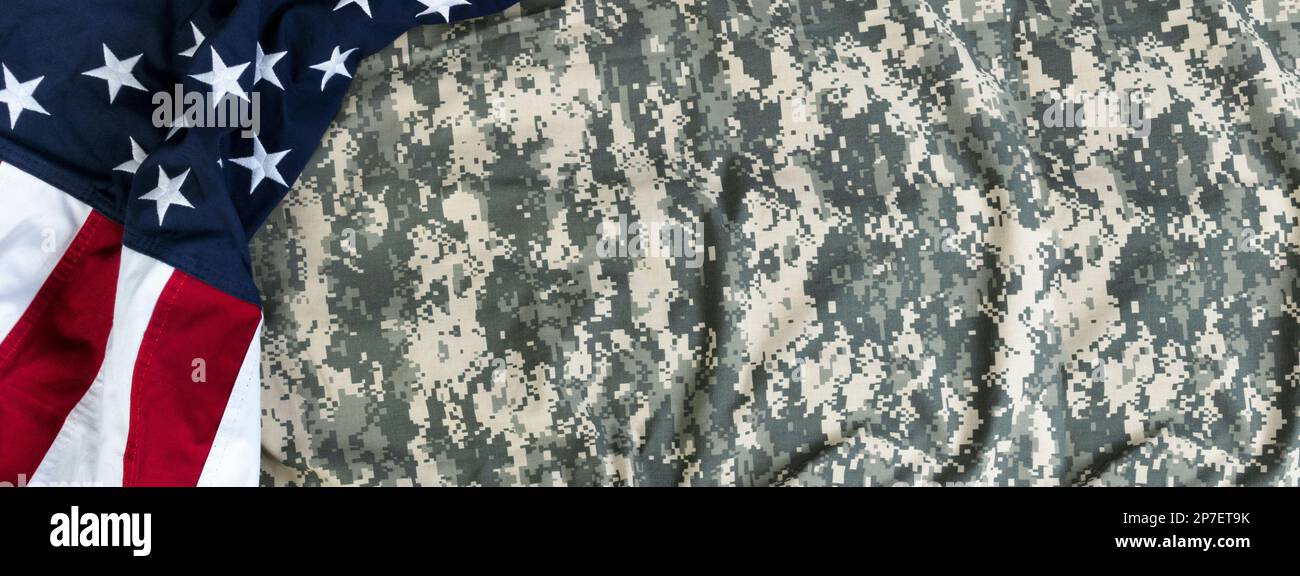 United States flag with camouflage military uniform for Independence, Veterans, labor, presidents or Memorial Day holiday concept Stock Photo