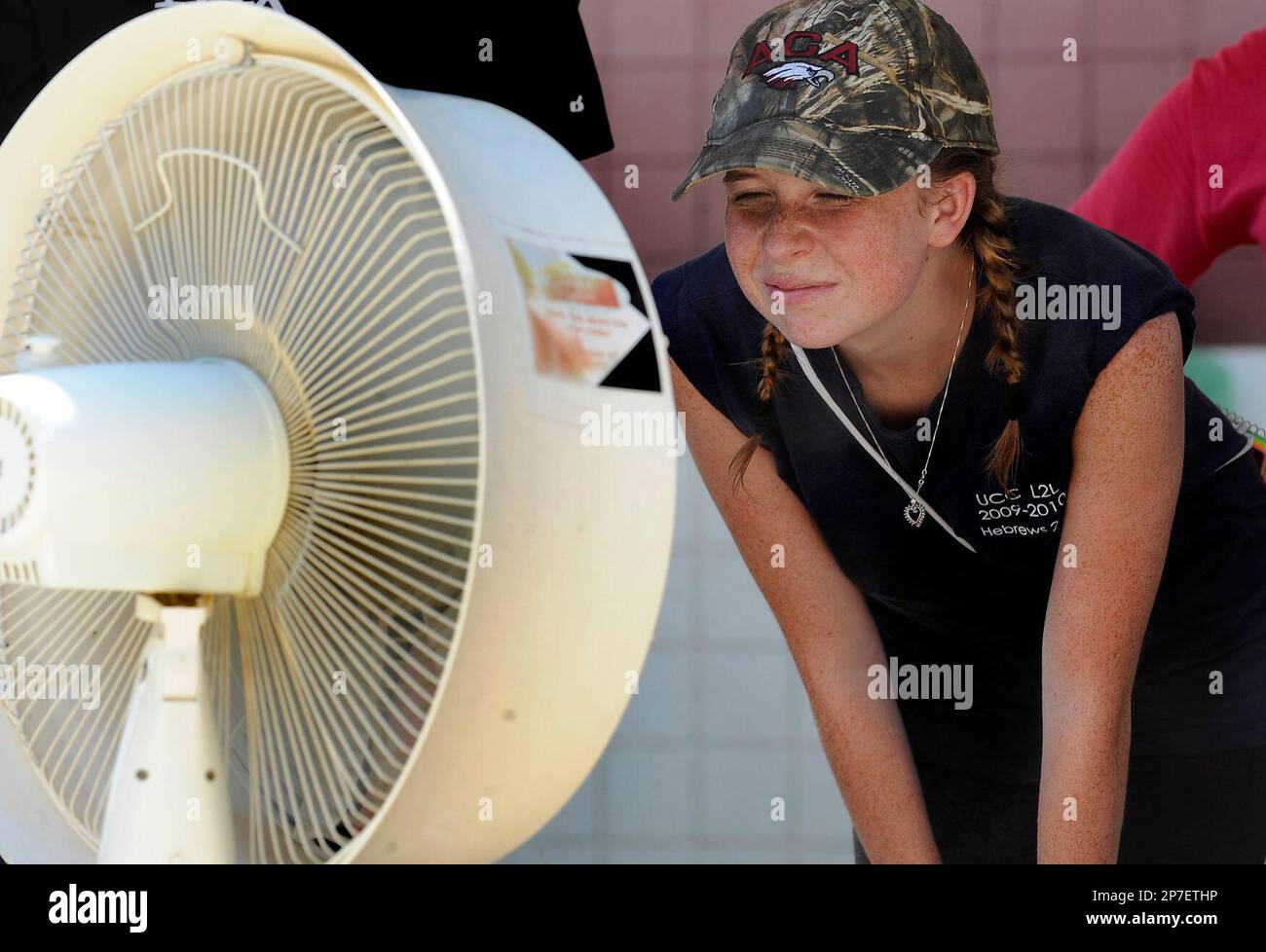 In this July 26, 2010 photo, Alabama Christian Academy marching band member  Kristina Clifton cools off in front of a misting fan during a break from  practice at the schools campus in