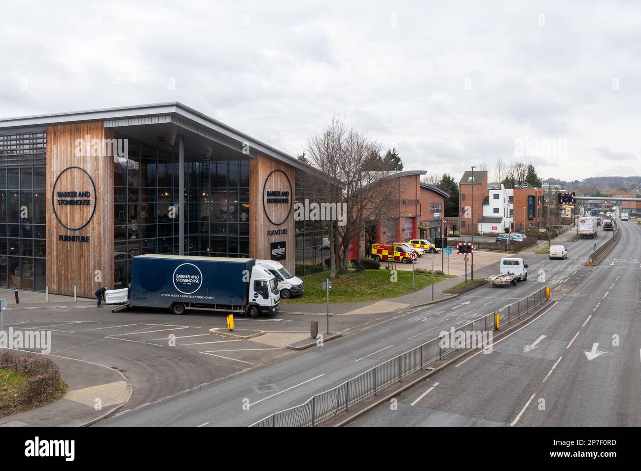 Barker and Stonehouse furniture store in Guildford town, Surrey, England, UK, with view of the A25 road and fire station Stock Photo