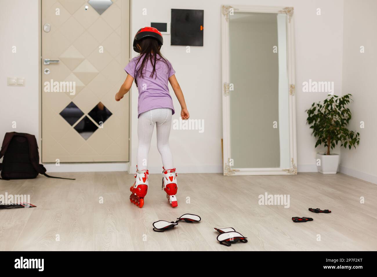 little girl is roller skating at home Stock Photo Alamy