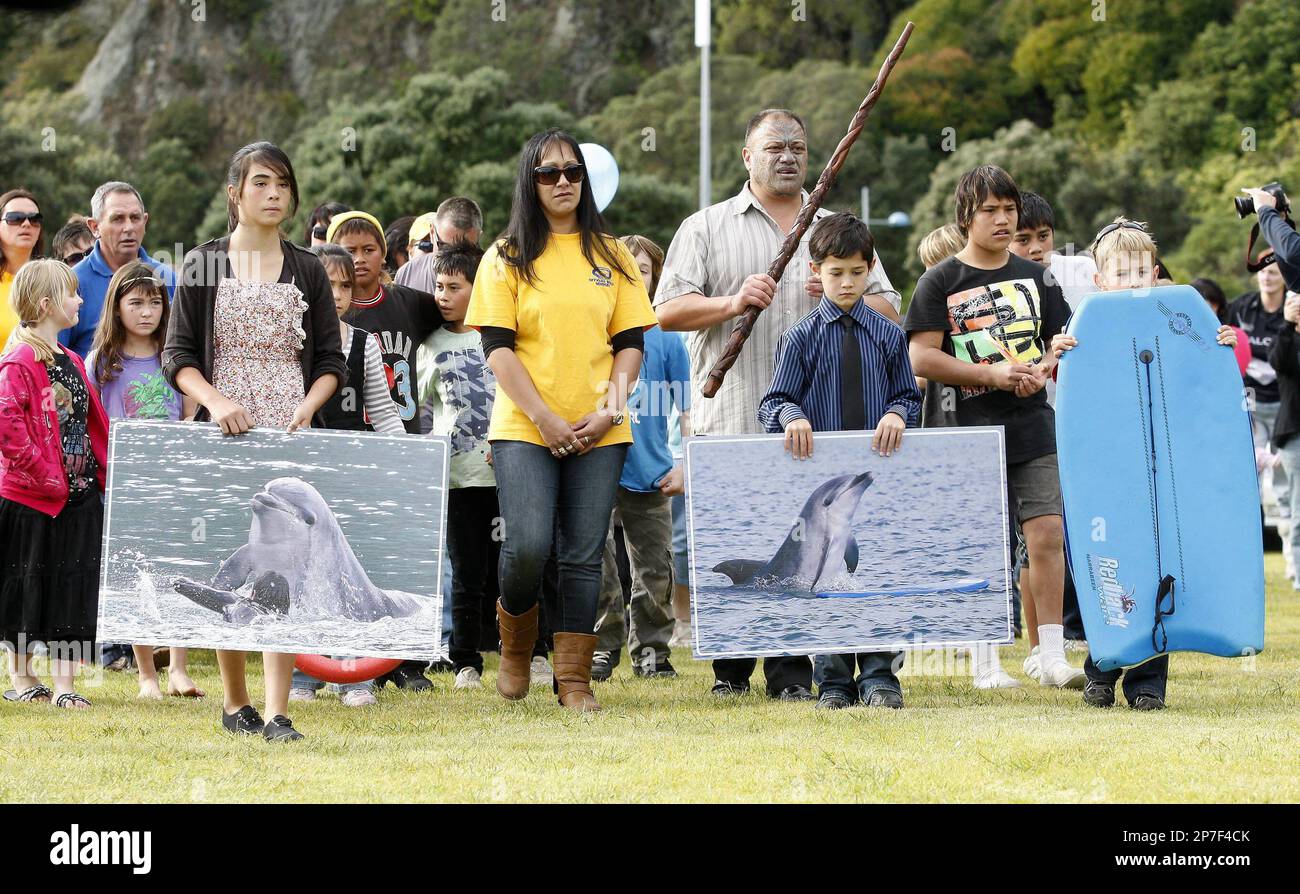 Locals carrying picture walk in a procession onto the Mataatua Reserve