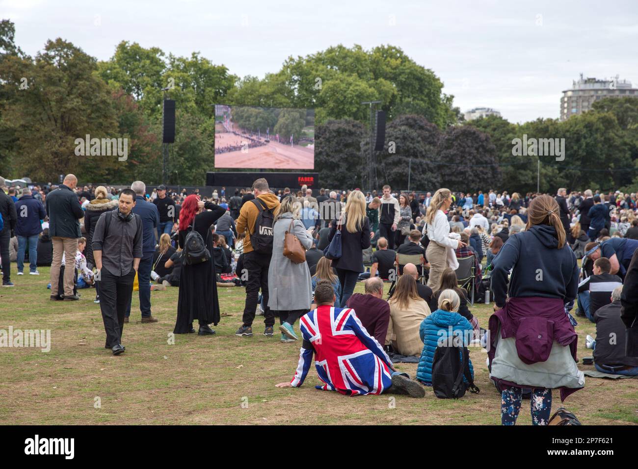 People watch the TV coverage of the late Queen Elizabeth II’s funeral