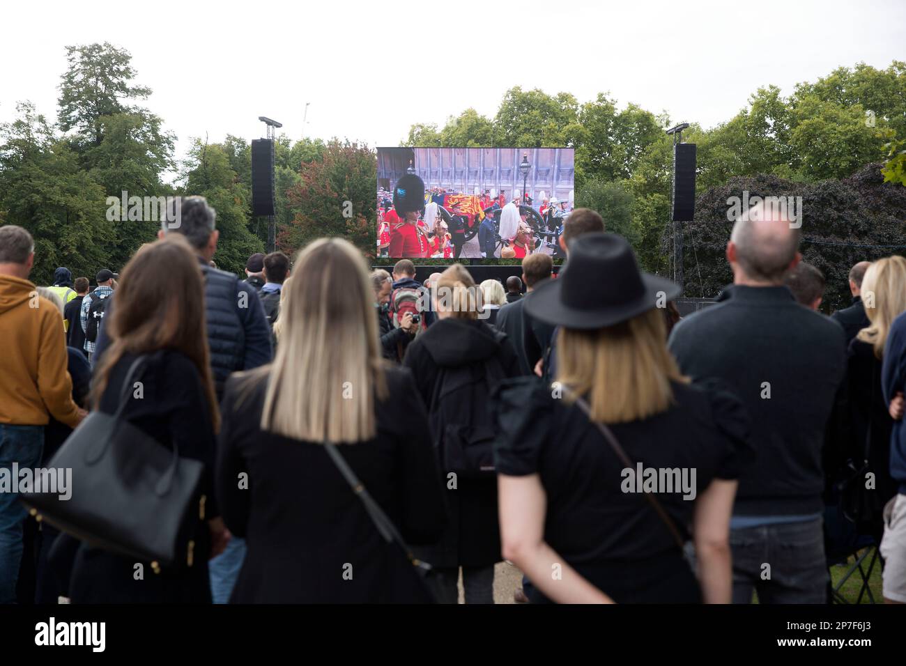 People watch the TV coverage of the late Queen Elizabeth II’s funeral