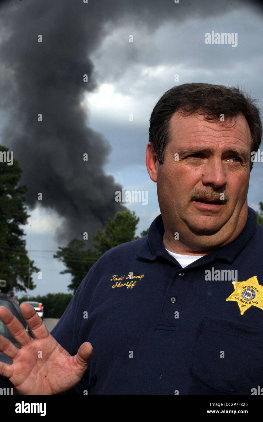 Clark County Sheriff Todd Kemp talks with media as a large plume