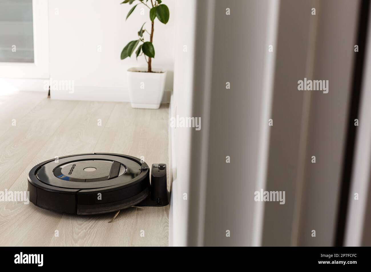 Robot vacuum cleaner return to charging at dock in clean room floor