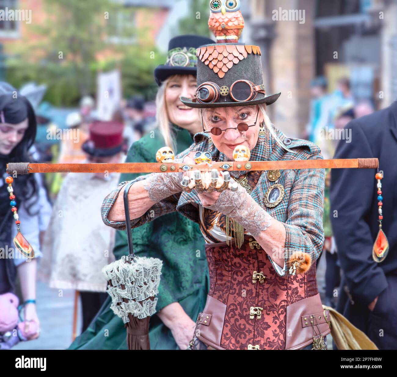 A female steampunk with a crossbow taking aim directly at the camera. Stock Photo